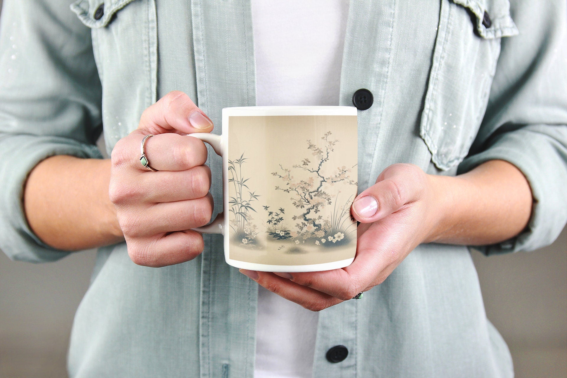 Zen Blossoms Japandi Style Ceramic Mug in white and blue colors, with delicate floral pattern and smooth texture