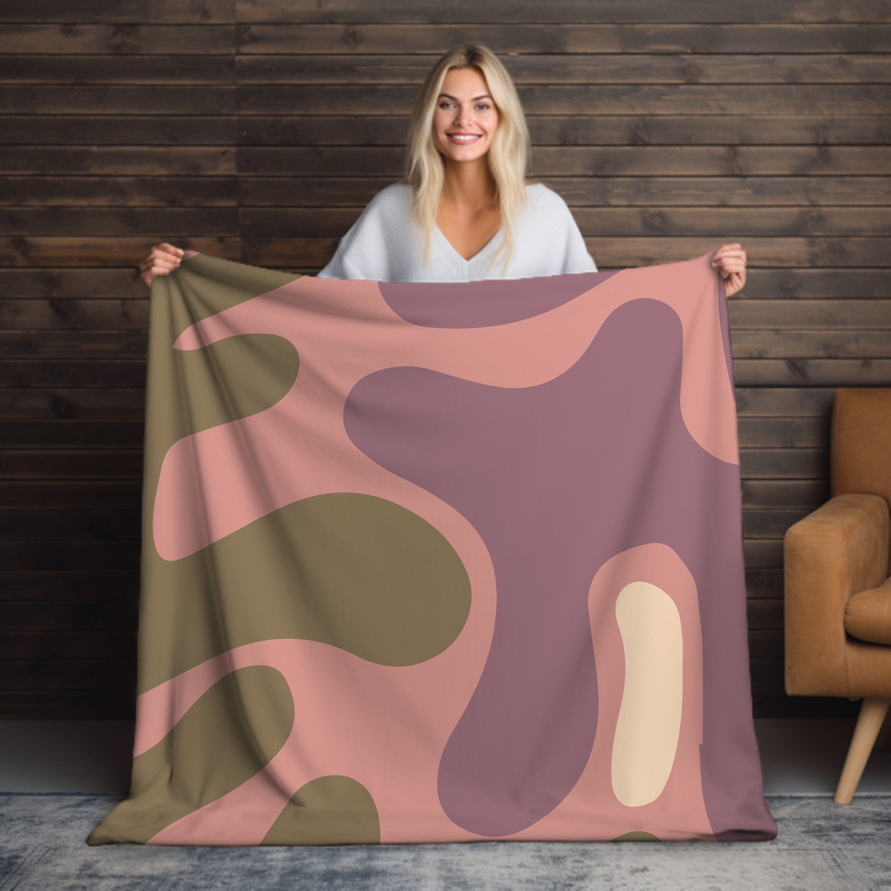 Soft and plush pink velveteen throw blanket with fringed edges and luxurious texture for cozy nights on the couch or bed